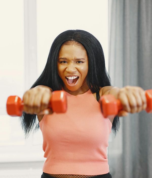 Energetic woman smiling during a light home workout session.